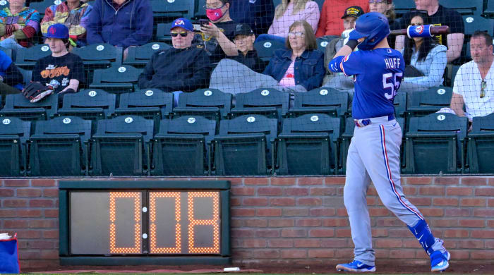 Rangers catcher Sam Huff waits in the batting circle as the pitch timer winds down in the background